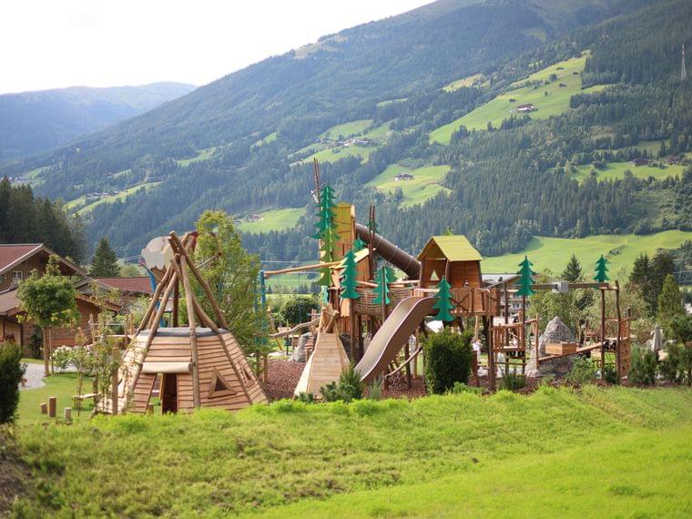Part of the adventure playground with the Wildkogel in the background, meadow and forest